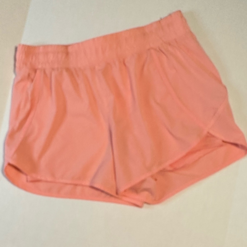 Avia running shirts with side zipper pocket. Peach color. Size 16-18.